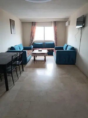 a living room with blue couches and a table at family apartment 31 in Marrakech