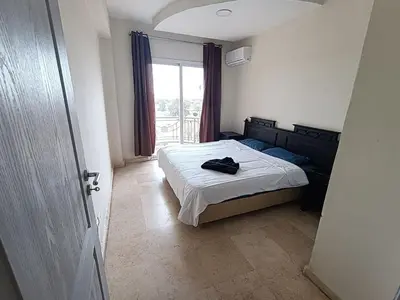 a bedroom with a bed and a window at family apartment 31 in Marrakech
