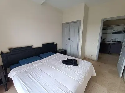 a bedroom with a bed with a black shirt on it at family apartment 31 in Marrakech