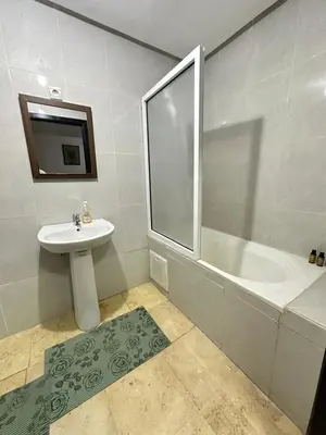 a bathroom with a sink and a bath tub at family apartment 32 in Marrakech