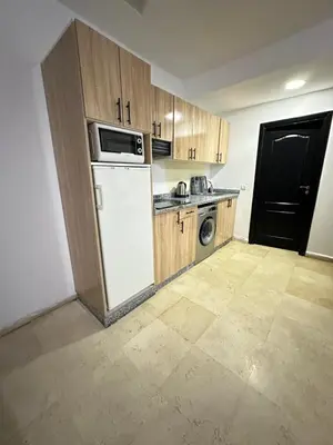 a kitchen with a white refrigerator and a microwave at family apartment 32 in Marrakech