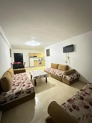 a living room with two couches and a table at family apartment 32 in Marrakech