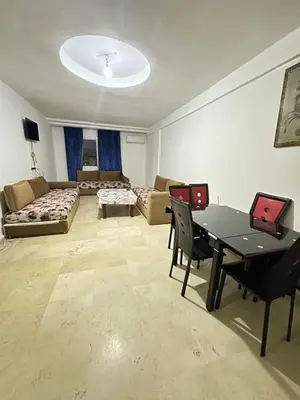 a living room with a table and a couch at family apartment 32 in Marrakech