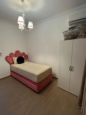 a bedroom with a bed with a cat sitting on it at Appartement a gueliz Marrakech in Marrakech