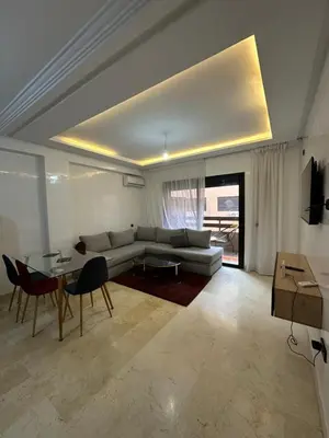 a living room with a couch and a table at Appartement a gueliz Marrakech in Marrakech