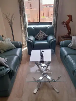 a living room with a couch and a table at Two Bedroom Luxury Appt with air conditioning parking and pool in Marrakech