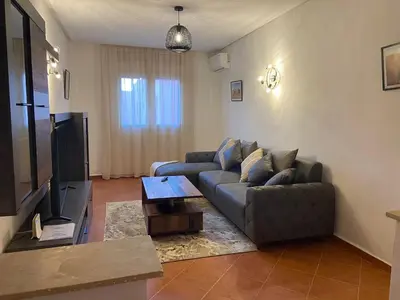 a living room with a couch and a television at 4-person apartment Guéliz Blida in Marrakech