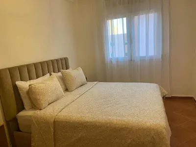 a bedroom with a bed with pillows and a window at 4-person apartment Guéliz Blida in Marrakech