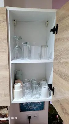 a cabinet filled with dishes and glass items at le CHARM J40 en face CTM Hivernage a 15mn de l'aéroport in Marrakech