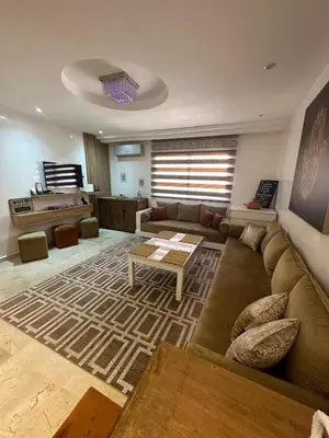 a living room with a couch and a table at le CHARM J40 en face CTM Hivernage a 15mn de l'aéroport in Marrakech