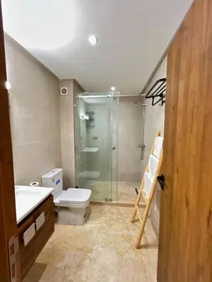 a bathroom with a glass shower and a toilet at Le Cosy de Gueliz avec Piscine et Belle Vue in Marrakech
