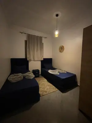 a bedroom with two beds and a window at Marrakech Center Getaway Apartment in Marrakech