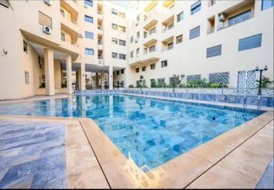 a large swimming pool in front of a building at Burj malak in Marrakech