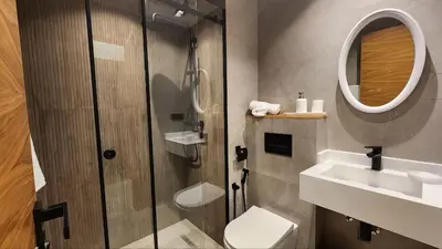 a bathroom with a shower and a toilet and a sink at Prestigia Golf Saphire in Marrakech