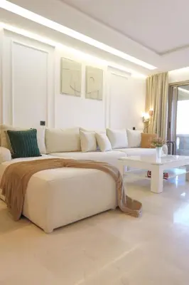 a living room with a large bed and a couch at Prestigia Golf Saphire in Marrakech