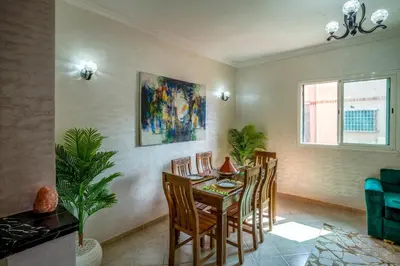 a dining room with a table and chairs at Spacious and Family Apartment in Marrakech