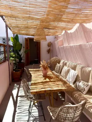 a living room with a table and a couch at Riad Doll LallaZwina in Marrakech