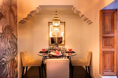 a dining room with a table and chairs at Riad Doll LallaZwina in Marrakech