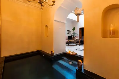 a living room with a pool in the floor at Riad Doll LallaZwina in Marrakech