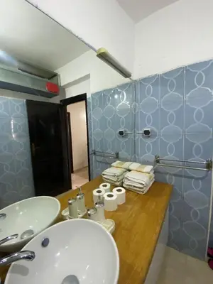 a bathroom with a sink and a counter with towels at appartement Alaoui in Marrakech