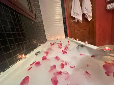 a bath tub filled with pink flower petals at Exclusive Luxury Stay with Pool, Jacuzzi and Service in Marrakech