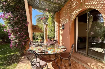 a table and chairs sitting on a patio at SEJOUR D'EXCEPTION LUXE Et SERENITE MARRAKECH in Marrakech