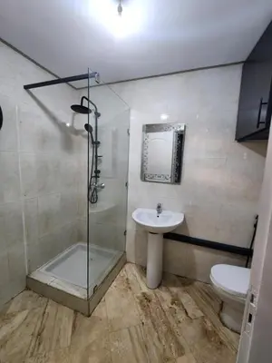 a bathroom with a shower and a sink and a toilet at Appartement de luxe in Marrakech
