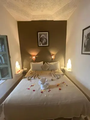 a bedroom with a bed with flowers on it at riad medina marrakech in Marrakech