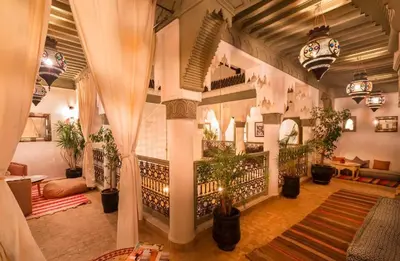 a living room with plants in a building at riad medina marrakech in Marrakech