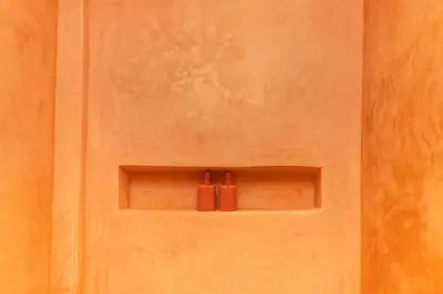 two red bottles sitting on a shelf on a door at Suite Soleil Charme, Confort & Emplacement Idéal in Marrakech