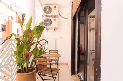 a balcony with chairs and plants in a building at Terra Cotta Suite, Luxe & Relaxing Bath in Marrakech