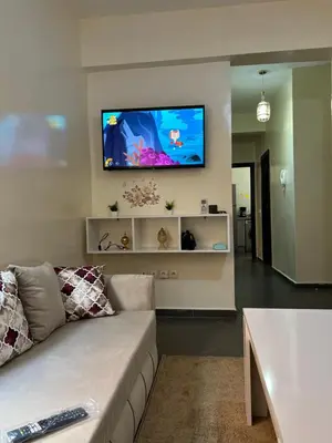 a living room with a couch and a flat screen tv at Le nid zen in Marrakech