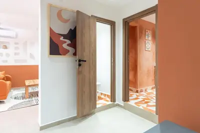 an open door in a room with an orange at Cozy suite Comfort et elegance in Marrakech