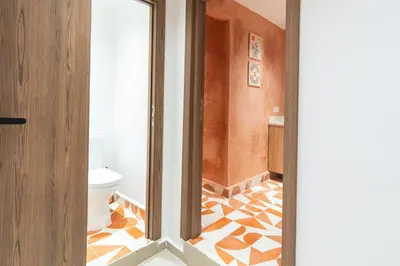 a bathroom with a toilet and a floor with orange at Cozy suite Comfort et elegance in Marrakech