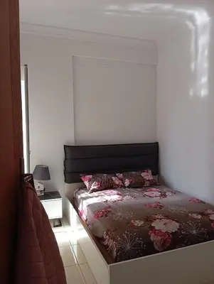 a bedroom with a bed with a black headboard at MmAéroport Menara Résidence abrar mhamid 1 in Marrakech