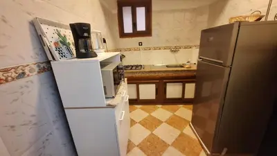 a kitchen with a refrigerator and a microwave at Appartement Studio Sejourkech, Gueliz Plaza in Marrakech