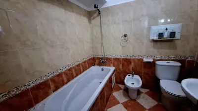 a bathroom with a tub and a toilet and a sink at Appartement Studio Sejourkech, Gueliz Plaza in Marrakech