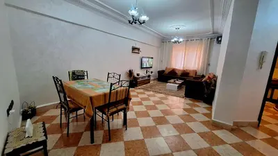 a living room with a table and a couch at Appartement Studio Sejourkech, Gueliz Plaza in Marrakech