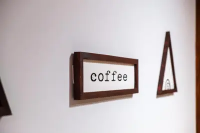 a picture frame with the word coffee on a wall at Modern Appart , Parking , Pool & Fiber wifi , Hivernage City Centre in Marrakech