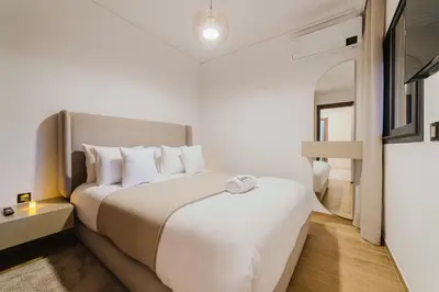 a bedroom with a large bed with white pillows at Modern Appart , Parking , Pool & Fiber wifi , Hivernage City Centre in Marrakech