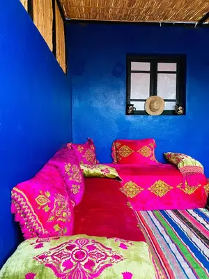 a blue room with a bed with pink sheets at Cozy Moroccan-style apartment in Marrakech
