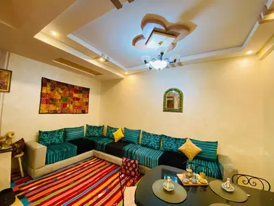 a living room with a couch and a table at Cozy Moroccan-style apartment in Marrakech