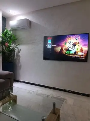 a flat screen tv on a wall in a living room at Modern apartment in the Heart of the City in Marrakech