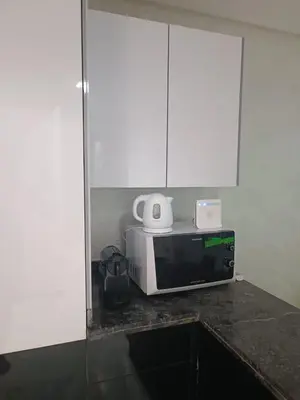 a microwave sitting on top of a kitchen counter at Modern apartment in the Heart of the City in Marrakech