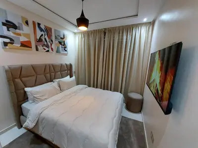a bedroom with a white bed in a room at Appartement centre ville marrakech in Marrakech