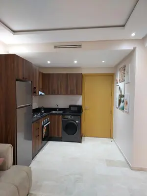 a kitchen with a stove and a washer and dryer at Appartement centre ville marrakech in Marrakech