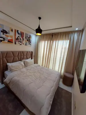 a bedroom with a large bed and a window at Appartement centre ville marrakech in Marrakech