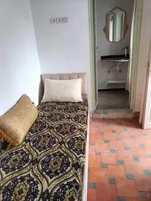 a bedroom with a bed and a mirror and a sink at Dar Le Monde in Marrakech