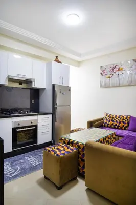a living room with a couch and a kitchen at حي الشرف in Marrakech
