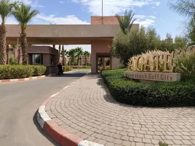 a building with a sign that reads village artificial gulf city at Appartement Prestigia Agate résidence avec piscine in Marrakech